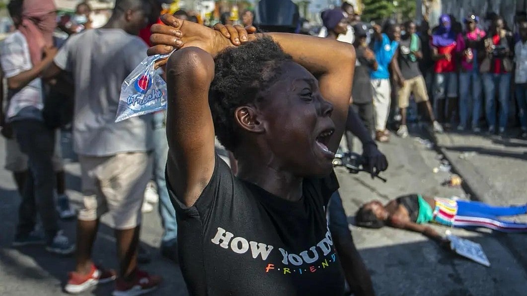 AP : Photo shows a woman in Haiti crying, 10 October 2022 |